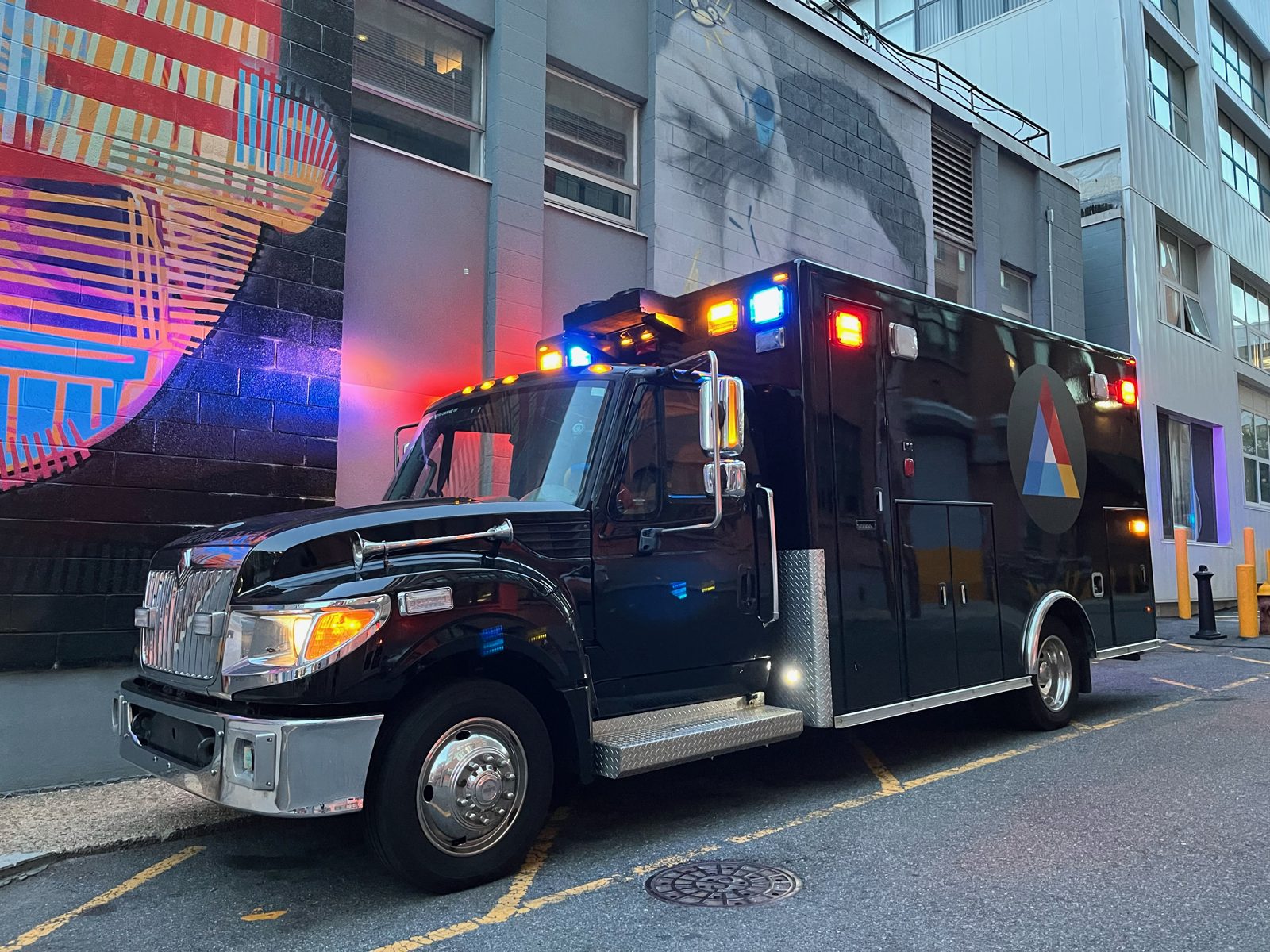 The SIC Tank mobile classroom parked with its lights on